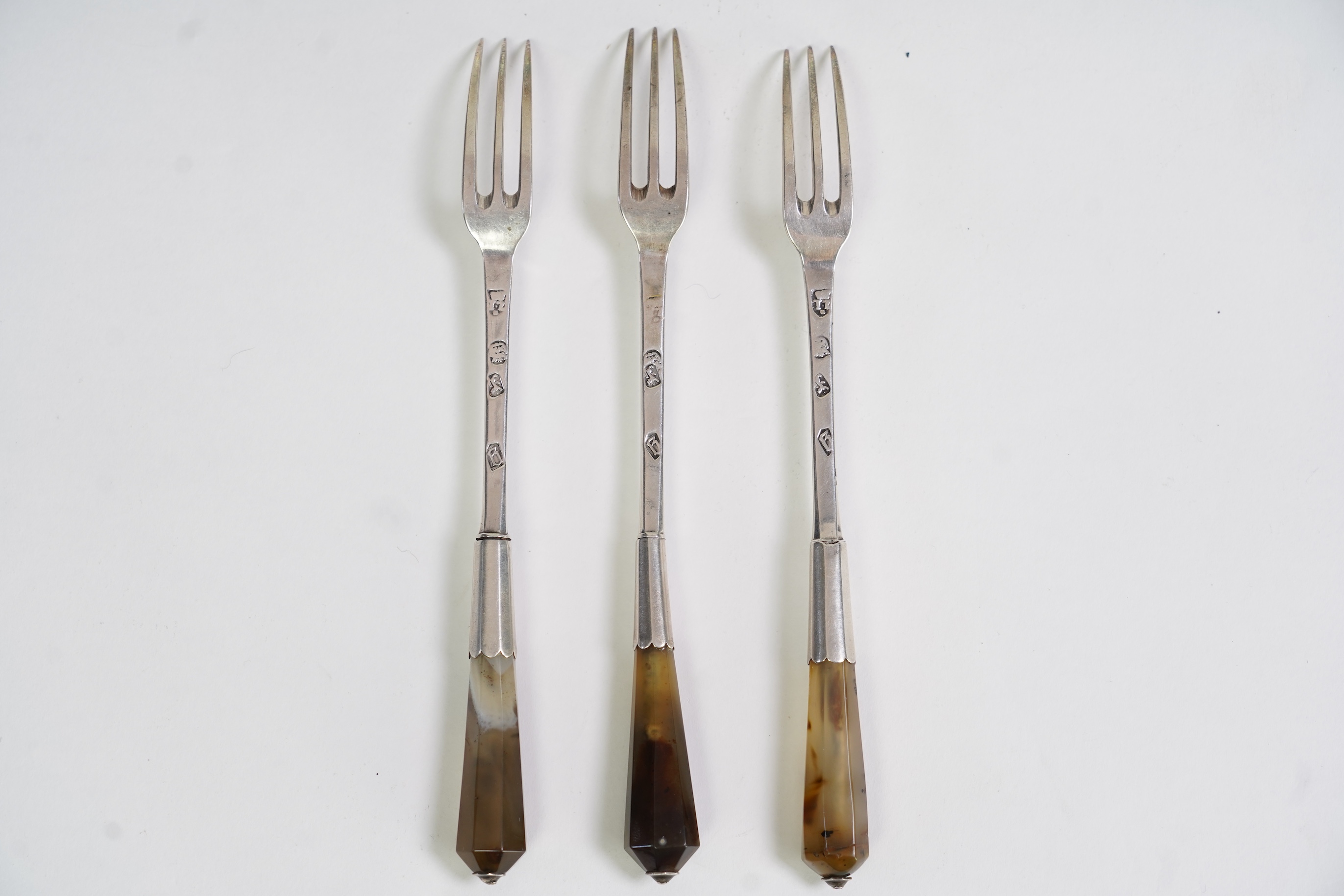 A set of three late Charles II agate handled silver three pronged forks, maker TZ with crown above and mullet below, (Jackson's ref. p.139)